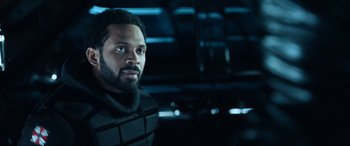 Movie still from “Resident Evil: Apocalypse” (2004), directed by Alexander Witt – A person wearing a suit; Close Up shot, Over the shoulder angle