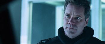 Movie still from “Resident Evil: Apocalypse” (2004), directed by Alexander Witt – A person wearing a black jacket; Close Up shot, Over the shoulder angle