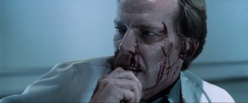Movie still from “Resident Evil: Apocalypse” (2004), directed by Alexander Witt – A person with blood on his face; Close Up shot, Low angle