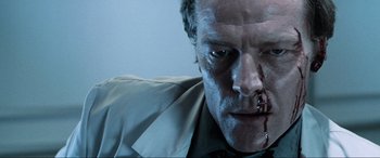 Movie still from “Resident Evil: Apocalypse” (2004), directed by Alexander Witt – A person with blood on his face; Close Up shot, Low angle