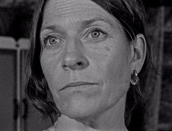 Movie still from “Bait” (2019), directed by Mark Jenkin – Black and white photograph of a woman looking at the camera; Close Up shot, Low angle