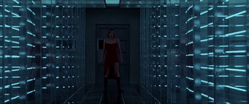 Movie still from “Resident Evil: Extinction” (2007), directed by Russell Mulcahy – A woman in a red dress standing in a room; Wide shot, Low angle