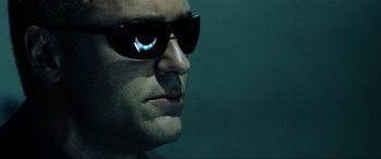 Movie still from “Resident Evil: Extinction” (2007), directed by Russell Mulcahy – A person wearing sunglasses; Close Up shot, Low angle