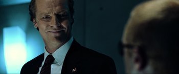 Movie still from “Resident Evil: Extinction” (2007), directed by Russell Mulcahy – A man in a suit and tie standing in front of a mirror; Close Up shot, Over the shoulder angle