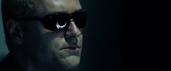 Movie still from “Resident Evil: Extinction” (2007), directed by Russell Mulcahy – A person wearing sunglasses; Close Up shot, Low angle
