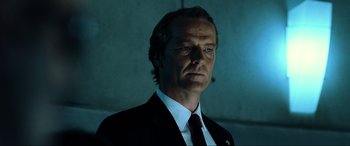 Movie still from “Resident Evil: Extinction” (2007), directed by Russell Mulcahy – A person wearing a suit and tie; Close Up shot, Low angle