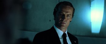 Movie still from “Resident Evil: Extinction” (2007), directed by Russell Mulcahy – A person wearing a suit and tie; Close Up shot, Low angle