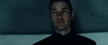 Movie still from “Resident Evil: Extinction” (2007), directed by Russell Mulcahy – A person wearing a shirt and tie; Close Up shot, Low angle