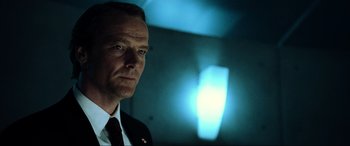 Movie still from “Resident Evil: Extinction” (2007), directed by Russell Mulcahy – A man in a suit and tie in a room; Close Up shot, Low angle