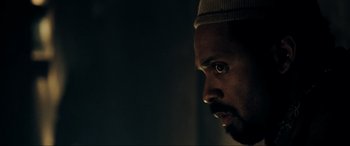 Movie still from “Resident Evil: Extinction” (2007), directed by Russell Mulcahy – A person's face in a dark room; Close Up shot, Low angle