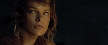 Movie still from “Resident Evil: Extinction” (2007), directed by Russell Mulcahy – A woman's face in the dark; Close Up shot, Low angle