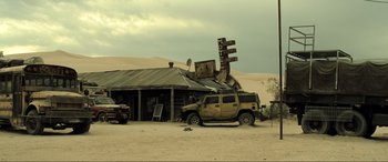 Movie still from “Resident Evil: Extinction” (2007), directed by Russell Mulcahy – An old truck parked in front of an abandoned building; Extreme Wide shot, High angle