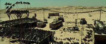 Movie still from “Resident Evil: Extinction” (2007), directed by Russell Mulcahy – A group of buses parked in the middle of the desert; Extreme Wide shot, High angle