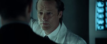 Movie still from “Resident Evil: Extinction” (2007), directed by Russell Mulcahy – A person wearing a shirt and a tie; Close Up shot, Over the shoulder angle