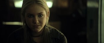 Movie still from “Resident Evil: Extinction” (2007), directed by Russell Mulcahy – A woman with long blonde hair wearing a black jacket; Close Up shot, Over the shoulder angle
