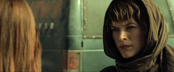 Movie still from “Resident Evil: Extinction” (2007), directed by Russell Mulcahy – A person with a hood is looking at the camera; Close Up shot, Over the shoulder angle