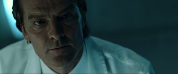 Movie still from “Resident Evil: Extinction” (2007), directed by Russell Mulcahy – A man's face in a dark room; Close Up shot, Low angle