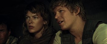 Movie still from “Resident Evil: Extinction” (2007), directed by Russell Mulcahy – A man and a woman sitting next to each other; Close Up shot, Over the shoulder angle