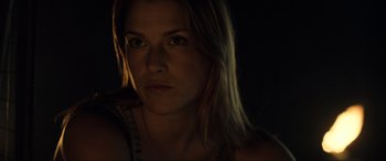 Movie still from “Resident Evil: Extinction” (2007), directed by Russell Mulcahy – A woman's face in the dark; Close Up shot, Low angle