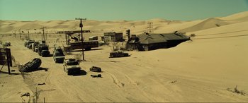 Movie still from “Resident Evil: Extinction” (2007), directed by Russell Mulcahy – Cars are parked in the sand in the desert; Extreme Wide shot, High angle