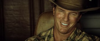 Movie still from “Resident Evil: Extinction” (2007), directed by Russell Mulcahy – A person wearing a cowboy hat; Close Up shot, Over the shoulder angle