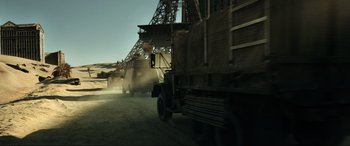 Movie still from “Resident Evil: Extinction” (2007), directed by Russell Mulcahy – A truck driving down a dirt road next to a bridge; Wide shot, Low angle