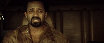 Movie still from “Resident Evil: Extinction” (2007), directed by Russell Mulcahy – A person with a beard; Close Up shot, Over the shoulder angle