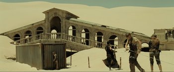 Movie still from “Resident Evil: Extinction” (2007), directed by Russell Mulcahy – A scene of a man walking across a bridge in the desert; Extreme Wide shot, Low angle