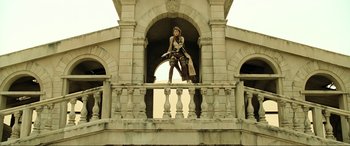 Movie still from “Resident Evil: Extinction” (2007), directed by Russell Mulcahy – A woman standing on the top of a building; Wide shot, Low angle