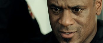 Movie still from “Resident Evil: Extinction” (2007), directed by Russell Mulcahy – A man's face with his eyes wide open; Extreme Close Up shot, Low angle