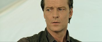 Movie still from “Resident Evil: Extinction” (2007), directed by Russell Mulcahy – A man's face in a green shirt; Close Up shot, Low angle