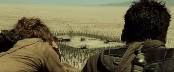 Movie still from “Resident Evil: Extinction” (2007), directed by Russell Mulcahy – Two men looking out over an open field from a hill; Extreme Wide shot, High angle