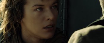 Movie still from “Resident Evil: Extinction” (2007), directed by Russell Mulcahy – A woman's face with tears in her eyes; Close Up shot, Over the shoulder angle