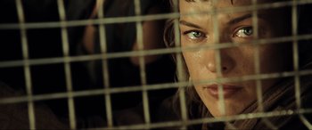 Movie still from “Resident Evil: Extinction” (2007), directed by Russell Mulcahy – A person looking through a fence; Close Up shot, Low angle