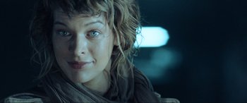 Movie still from “Resident Evil: Extinction” (2007), directed by Russell Mulcahy – A woman's face in a dark room; Close Up shot, Low angle