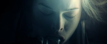 Movie still from “Resident Evil: Extinction” (2007), directed by Russell Mulcahy – A woman's face with water pouring out of her mouth; Extreme Close Up shot, Overhead angle