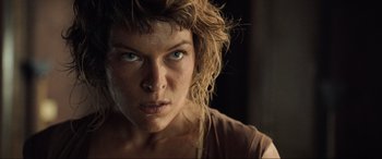 Movie still from “Resident Evil: Extinction” (2007), directed by Russell Mulcahy – A woman's face in a dark room; Close Up shot, Low angle