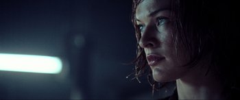 Movie still from “Resident Evil: Extinction” (2007), directed by Russell Mulcahy – A woman's face in the dark; Close Up shot, Low angle