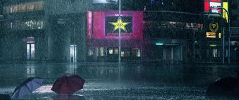 Movie still from “Resident Evil: Retribution” (2012), directed by Paul W.S. Anderson – A person holding an umbrella in the middle of a street; Extreme Wide shot, High angle