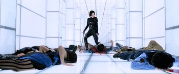 Movie still from “Resident Evil: Retribution” (2012), directed by Paul W.S. Anderson – A woman chained to the ground in a room with white walls; Wide shot, High angle