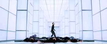 Movie still from “Resident Evil: Retribution” (2012), directed by Paul W.S. Anderson – A group of people laying on the ground in a room; Wide shot, Low angle