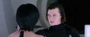 Movie still from “Resident Evil: Retribution” (2012), directed by Paul W.S. Anderson – A woman looking into a mirror while standing next to another woman; Close Up shot, Over the shoulder angle