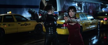 Movie still from “Resident Evil: Retribution” (2012), directed by Paul W.S. Anderson – A couple of women holding guns in a parking lot; Medium shot, Low angle
