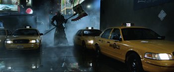 Movie still from “Resident Evil: Retribution” (2012), directed by Paul W.S. Anderson – A man that is standing in front of a taxi; Wide shot, Low angle