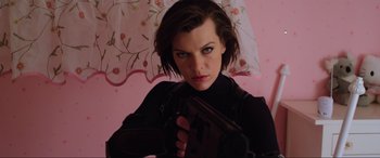 Movie still from “Resident Evil: Retribution” (2012), directed by Paul W.S. Anderson – A woman holding a gun while standing under an umbrella; Close Up shot, Low angle