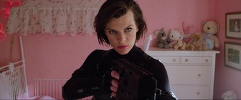 Movie still from “Resident Evil: Retribution” (2012), directed by Paul W.S. Anderson – A woman holding a gun while wearing a black outfit; Close Up shot, Low angle
