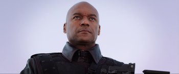 Movie still from “Resident Evil: Retribution” (2012), directed by Paul W.S. Anderson – A man in a black jacket is looking at the camera; Close Up shot, Low angle