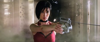 Movie still from “Resident Evil: Retribution” (2012), directed by Paul W.S. Anderson – A woman holding a gun in her hand; Close Up shot, Low angle