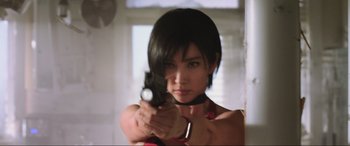 Movie still from “Resident Evil: Retribution” (2012), directed by Paul W.S. Anderson – A woman is holding a gun in a room; Close Up shot, Low angle