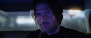 Movie still from “Resident Evil: Retribution” (2012), directed by Paul W.S. Anderson – A person with long dark hair; Close Up shot, Over the shoulder angle